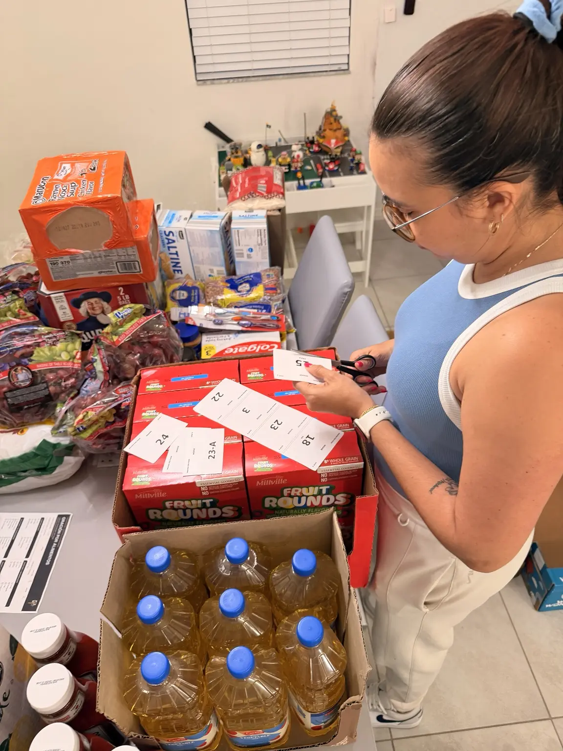 Preparing and labeling groceries for Prayer for Food household deliveries